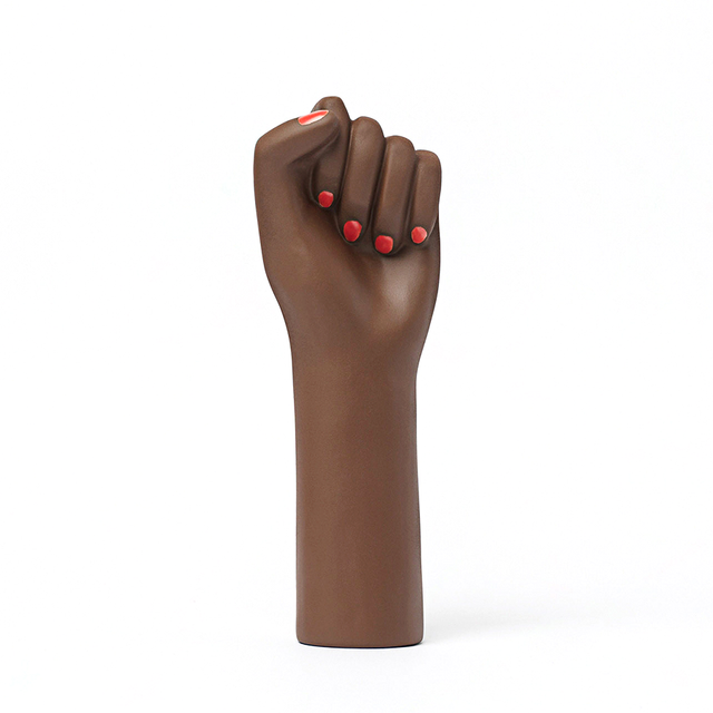 ceramic vase shaped as a fighting woman's hand, with painted red nails. A symbol of resilience, bravery, and strength.