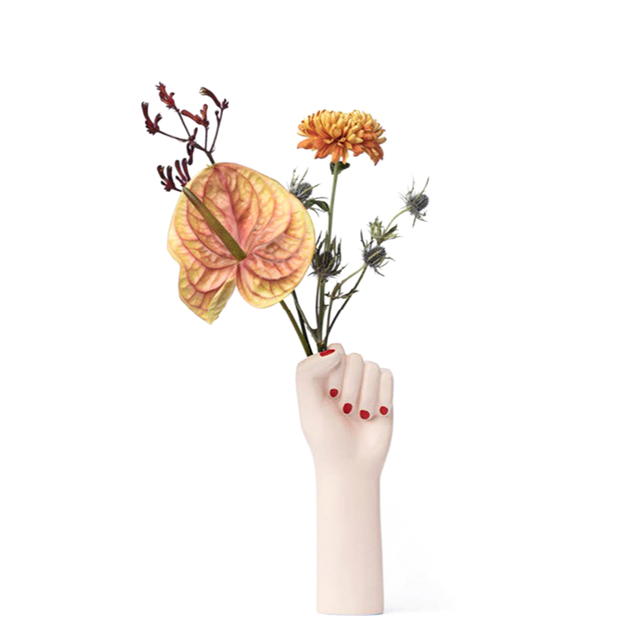 ceramic vase shaped as a fighting woman's hand, with painted red nails. A symbol of resilience, bravery, and strength.