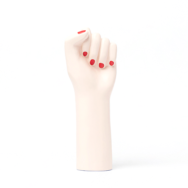 ceramic vase shaped as a fighting woman's hand, with painted red nails. A symbol of resilience, bravery, and strength.